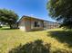 The house features a screened-in pool and nice backyard, all enhanced by mature trees and a well-maintained lawn at 3464 Misty View Dr, Spring Hill, FL 34609