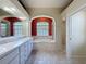 Bathroom featuring dual sinks, a large soaking tub, and separate shower at 3464 Misty View Dr, Spring Hill, FL 34609