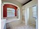 Bright bathroom features a large soaking tub, tiled shower, and separate water closet at 3464 Misty View Dr, Spring Hill, FL 34609
