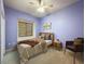 Cozy bedroom features a neutral color palette, a reading nook, and soft natural light at 3464 Misty View Dr, Spring Hill, FL 34609