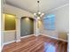 The dining room features hardwood floors, large windows, and decorative chandelier lighting at 3464 Misty View Dr, Spring Hill, FL 34609