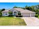 Charming single-story home features a well-manicured lawn, brick driveway, and a neutral color palette at 3464 Misty View Dr, Spring Hill, FL 34609