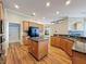 Spacious kitchen featuring wood floors, an island, granite countertops, and modern appliances at 3464 Misty View Dr, Spring Hill, FL 34609