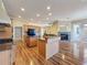 Kitchen featuring wood floors, an island, and a view of the living area at 3464 Misty View Dr, Spring Hill, FL 34609