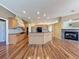 Bright kitchen and dining area featuring wood floors, an island, and a fireplace at 3464 Misty View Dr, Spring Hill, FL 34609