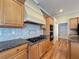 Close-up of kitchen with granite countertops, tile backsplash, and modern appliances at 3464 Misty View Dr, Spring Hill, FL 34609
