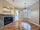 Living area featuring wood floors, a fireplace, a chandelier, and lots of light at 3464 Misty View Dr, Spring Hill, FL 34609