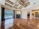 Spacious living room with hardwood floors, fireplace, and sliding doors leading to the screened-in pool at 3464 Misty View Dr, Spring Hill, FL 34609