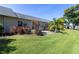 The grassy backyard features tropical plants and a paver patio at 3819 Teeside Dr, New Port Richey, FL 34655