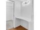 A custom closet features shelving, a desk, and a light fixture at 3819 Teeside Dr, New Port Richey, FL 34655