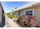 Exterior view of the home with lush landscaping along the walkway at 3819 Teeside Dr, New Port Richey, FL 34655