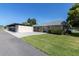 A single-story home has a carport and well-manicured lawn at 3819 Teeside Dr, New Port Richey, FL 34655