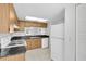 Kitchen showcasing appliances and tile flooring with a view to the dining area at 3819 Teeside Dr, New Port Richey, FL 34655
