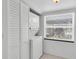Bright laundry room with stacked washer and dryer unit, next to a window at 3819 Teeside Dr, New Port Richey, FL 34655