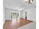 Bright living room featuring hardwood and tile floors, ceiling fan, and plenty of natural light at 3819 Teeside Dr, New Port Richey, FL 34655