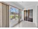 Enclosed sun room with tile floors and windows allowing natural light and views to the outdoors at 3819 Teeside Dr, New Port Richey, FL 34655