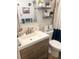 Bathroom featuring a white sink, wooden drawers, decorative shelves, and a blue accent shower curtain at 4264 Tamargo Dr # 3, New Port Richey, FL 34652