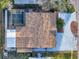 Overhead shot of home featuring screened pool, outdoor patio, and updated roof at 4934 Amherst Ct, New Port Richey, FL 34652