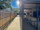 View from the side yard showcasing the screened patio area and the fenced perimeter at 4934 Amherst Ct, New Port Richey, FL 34652