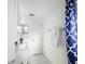 Well-lit bathroom featuring a white vanity, fresh towels, and wainscoting at 4934 Amherst Ct, New Port Richey, FL 34652