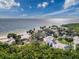 Scenic beach view with palm trees, picnic shelters, and parking, perfect for a relaxing day by the water at 4934 Amherst Ct, New Port Richey, FL 34652