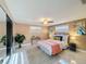Comfortable bedroom featuring a queen-size bed, mirrored closet doors, and natural light at 4934 Amherst Ct, New Port Richey, FL 34652
