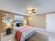 Cozy bedroom with a queen-size bed, ceiling fan, neutral walls, and stylish decor at 4934 Amherst Ct, New Port Richey, FL 34652