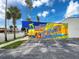 Colorful mural welcoming visitors to New Port Richey with vibrant imagery of palm trees and the waterfront at 4934 Amherst Ct, New Port Richey, FL 34652
