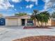 Charming home with a brick facade, well-manicured landscaping, and a two-car garage at 4934 Amherst Ct, New Port Richey, FL 34652