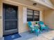 Inviting front porch with seating, perfect for enjoying a morning coffee or evening relaxation at 4934 Amherst Ct, New Port Richey, FL 34652