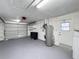A spacious garage featuring a clean, painted floor, water heater, and garage door providing a functional area at 4934 Amherst Ct, New Port Richey, FL 34652
