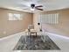 Home office with modern desk, neutral walls, tile floors, and bright natural light from two windows at 4934 Amherst Ct, New Port Richey, FL 34652