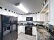 This kitchen features a black and white design with stainless steel appliances and ample cabinet space at 4934 Amherst Ct, New Port Richey, FL 34652