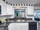 Kitchen featuring granite countertops, white cabinets, and views through to an adjacent living area at 4934 Amherst Ct, New Port Richey, FL 34652