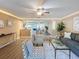 A modern living room flows into the dining area, creating an open and inviting atmosphere with stylish decor at 4934 Amherst Ct, New Port Richey, FL 34652
