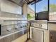 Stainless steel outdoor kitchen with a KitchenAid grill and a granite countertop at 4934 Amherst Ct, New Port Richey, FL 34652
