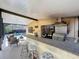 Outdoor kitchen with a built-in grill, granite countertop bar, and a view of the refreshing screened-in pool at 4934 Amherst Ct, New Port Richey, FL 34652