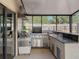 Covered outdoor kitchen featuring stainless steel appliances, granite countertops, and ample counter space at 4934 Amherst Ct, New Port Richey, FL 34652