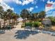 An aerial view showcases the park entrance with palm trees, amenities, parking, and an American flag at 4934 Amherst Ct, New Port Richey, FL 34652