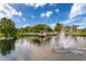 Wide pond view featuring a water fountain and gazebo, nestled amidst lush greenery and apartment homes at 4934 Amherst Ct, New Port Richey, FL 34652