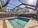 Beautiful pool area enclosed by a screened lanai, offering privacy and a serene outdoor experience at 4934 Amherst Ct, New Port Richey, FL 34652