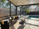 Relaxing screened in pool patio with elegant furniture and decor at 4934 Amherst Ct, New Port Richey, FL 34652
