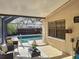 Cozy screened patio leading to a private pool area with comfortable seating and natural light at 4934 Amherst Ct, New Port Richey, FL 34652