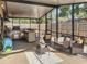 Relaxing screened patio with wicker furniture, ceiling fan, and outdoor kitchen at 4934 Amherst Ct, New Port Richey, FL 34652