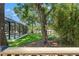Lush backyard with a screened in pool and patio at 520 Lafayette Blvd, Oldsmar, FL 34677