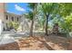 Home's lush backyard with a play structure, patio, and lush, green landscaping at 520 Lafayette Blvd, Oldsmar, FL 34677