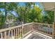 Balcony view of fenced backyard with lush tropical foliage, mature trees, and storage building at 520 Lafayette Blvd, Oldsmar, FL 34677
