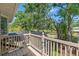 Upper balcony view overlooking a screened pool area, lush landscaping, and surrounding mature trees at 520 Lafayette Blvd, Oldsmar, FL 34677