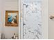 Shower with marble tile accent wall and framed wall art at 520 Lafayette Blvd, Oldsmar, FL 34677