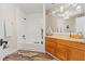 Nautical themed bathroom with a bathtub/shower combination, wooden vanity, and shark rug at 520 Lafayette Blvd, Oldsmar, FL 34677